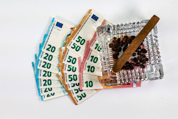 50 20 10 euro banknotes with ashtray and cigar on white background - Photo, Image