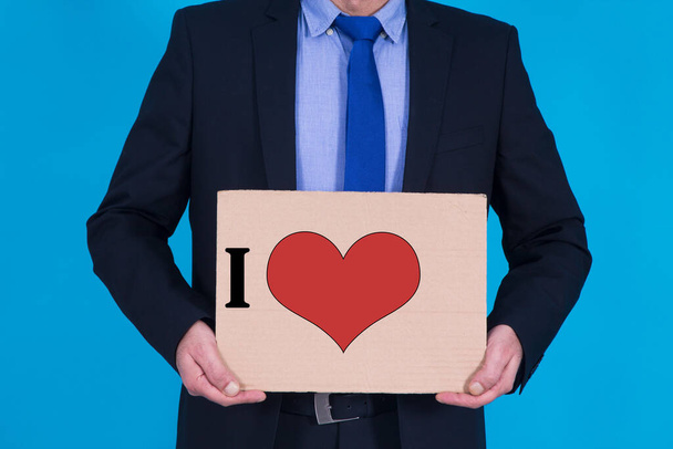 businessman holding sign and text with heart, happy valentines concept - Foto, immagini