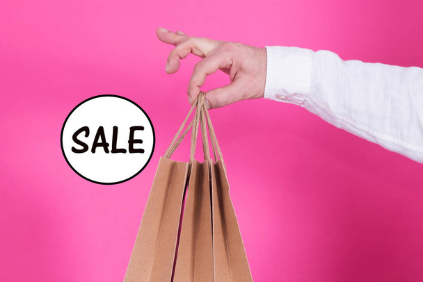 man with bags in hand and text, sales concept - Photo, Image