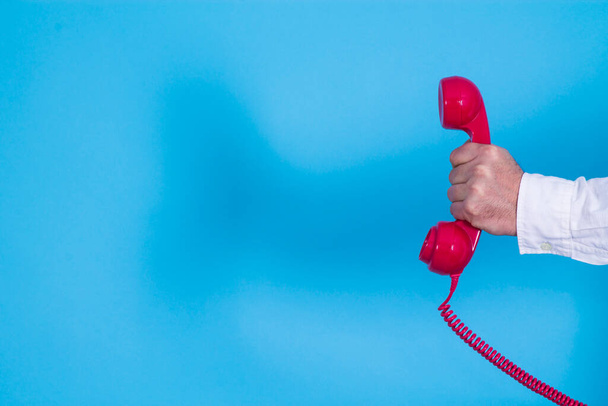 hand holding retro red telephone - Photo, Image