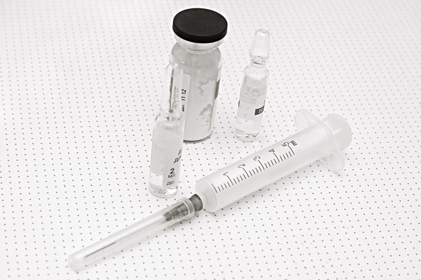Jeringas y viales para inyección sobre fondo blanco
 - Foto, imagen