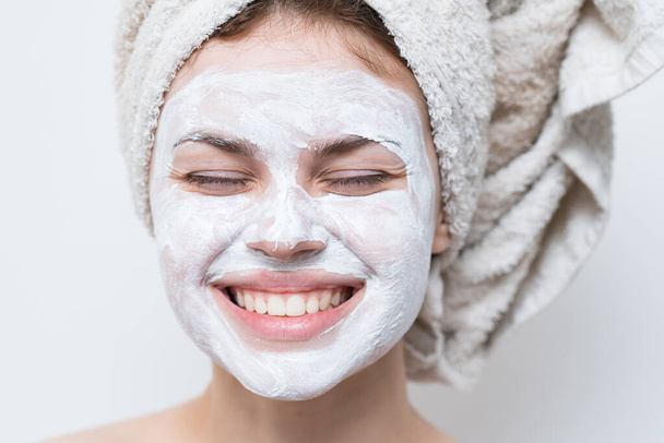 woman with bare shoulders towel on head face mask skin care close-up - Fotó, kép