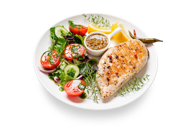 Grilled chicken breast with fresh vegetable salad. Healthy food, keto diet, diet lunch concept. isolated on white background - Photo, Image