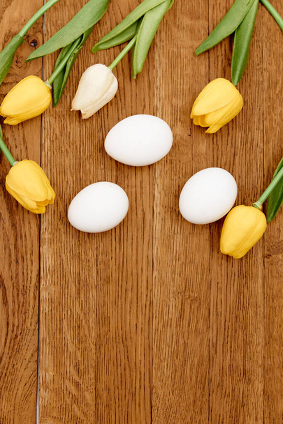 μπουκέτο από ανοιξιάτικα λουλούδια πασχαλινά αυγά διακόσμηση ξύλινο φόντο - Φωτογραφία, εικόνα