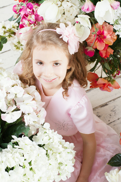 Portrait of little cute girl with flowers  - Фото, зображення