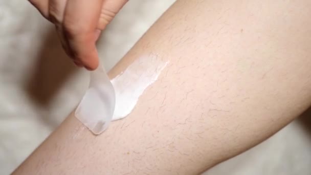 Close up applying hair removal cream. Shaving legs  - Footage, Video