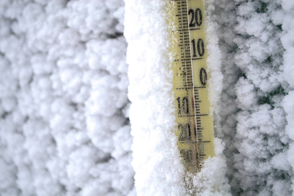 The thermometer is covered in snow after the storm. - Photo, Image