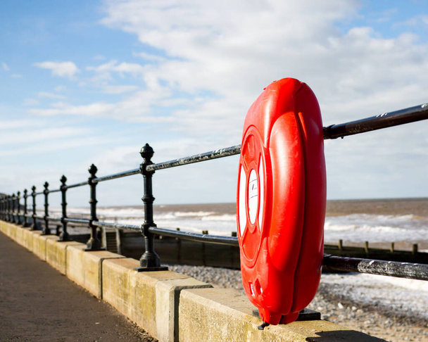 Life ring on the railings on the promenade of Cromer beach - Photo, Image