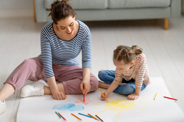 Happy family. Mother and daughter drawing together. Adult woman spending time with child girl.    - Fotó, kép
