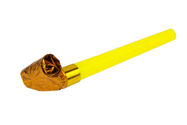 Rolled gold foil festive noisemaker or party whistle horn isolated on the white background - Foto, immagini