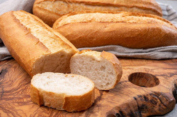 Ingredient for French breakfast, fresh baked crispy baguette white bread close up - Photo, Image