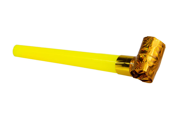 Rolled gold foil festive noisemaker or party whistle horn isolated on the white background - Foto, afbeelding