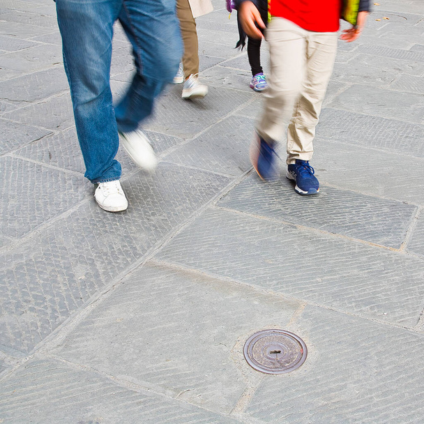 Ihmiset kävelevät jalankulkijoiden vyöhykkeellä kivetty pieni kivi. - Valokuva, kuva