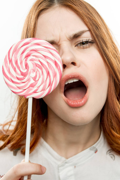 cheerful pretty woman with lollipop near face sweets dessert - Foto, imagen