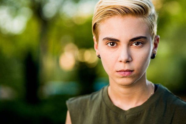 Tomboy androgynous lesbian non binary beauty in casual clothes gender lgtbi sex education. Sexual identity discrimination is a social problem in a diversity orientation like lesbian, homosexuality  - Photo, Image