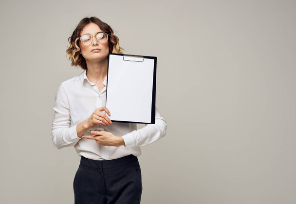 Business woman in a shirt holds a folder with a white sheet of paper Copy Space - Fotó, kép