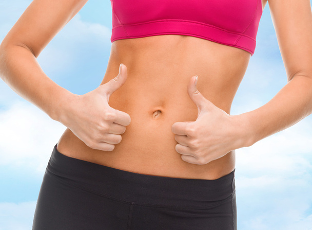 Close up of female abs and hands showing thumbs up - Foto, Imagem