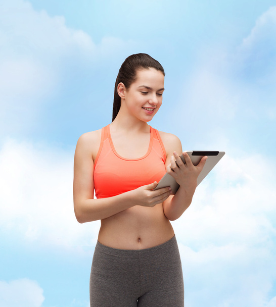 Sporty woman with tablet pc computer - Fotó, kép