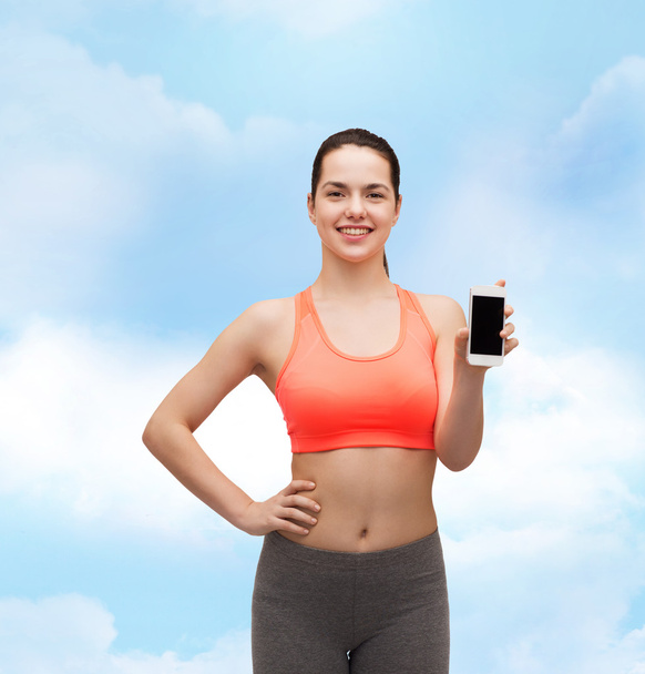 Sporty woman with smartphone - Foto, Imagem