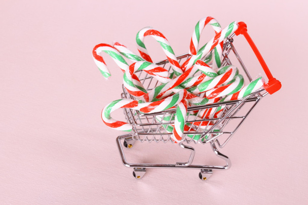 Full shopping cart with candy cane - Zdjęcie, obraz
