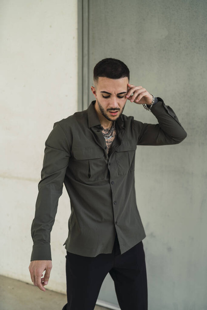 A Caucasian young man in casual style with chain and tattoos - Photo, Image