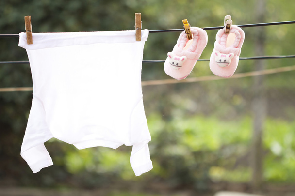 Baby clothes hanging on the clothesline - Foto, immagini