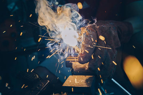 Man hand  Industrial worker welding metal at factory workshop at Steel welding plants - Photo, Image