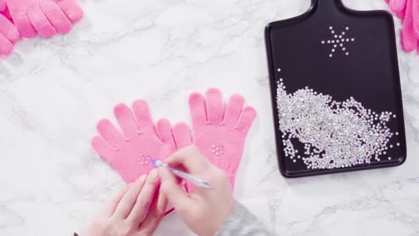 Rhinestone pink kids gloves with snowflake shapes. - Footage, Video