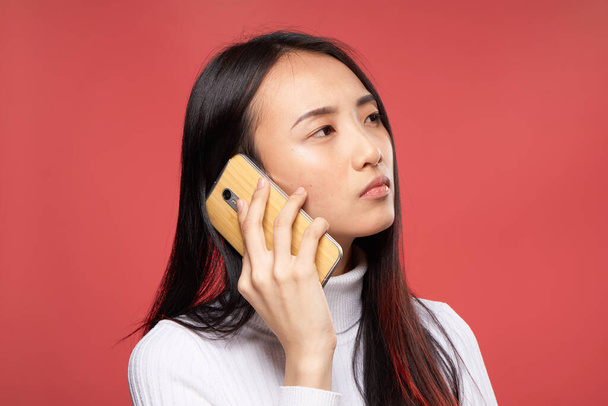 pretty brunette phone communication technology red background model - Foto, Imagem