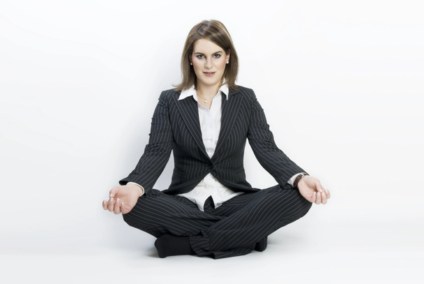 Young businesswoman sitting in lotus position. - Photo, Image