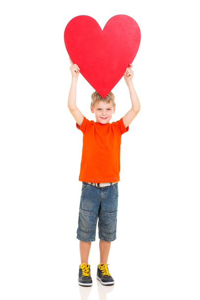 boy holding up red heart shape  - Фото, зображення