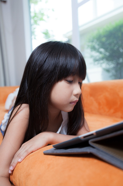 Girl playing with tablet. - Фото, зображення