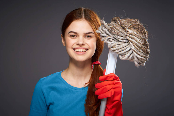 emotional woman with a mop in hand cleaning rooms home care - Fotoğraf, Görsel