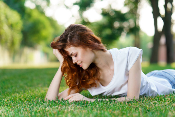 woman lies in the park on the lawn in the fresh air - Photo, Image