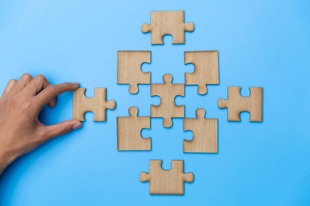 Hand connect jigsaw parts with word problem  solution.   symbol of association and connection. business strategy. Teamwork concept. - Photo, Image