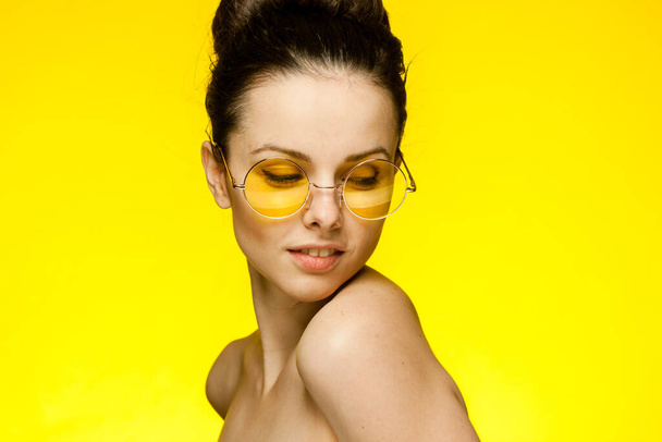 brunette with bare shoulders attractive glamor look yellow background - Photo, Image