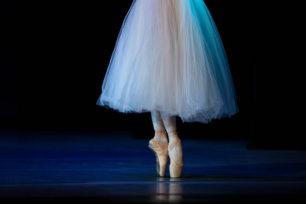 Detailní záběr baletky, jak tančí izolovaně na jevišti. Ballerina nohy detailní up - Fotografie, Obrázek