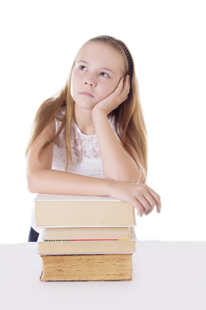Thoughtful schoolgirl with pile of books - Zdjęcie, obraz