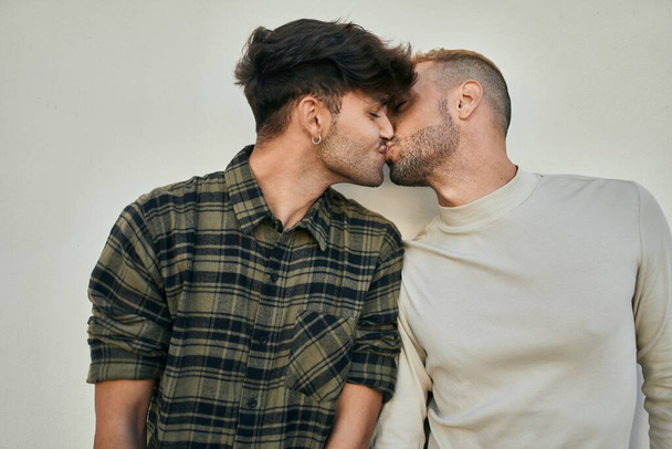 Young gay couple hugging and kissing at the city. - Photo, Image