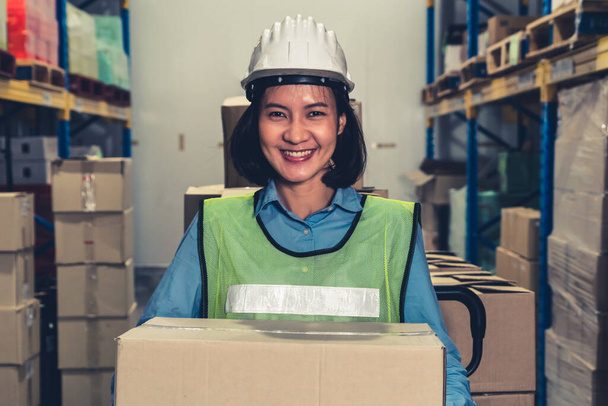 Portrait of young Asian woman warehouse worker smiling in the storehouse - Foto, immagini