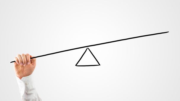 Man constructing a seesaw with a rod and triangle - Photo, Image