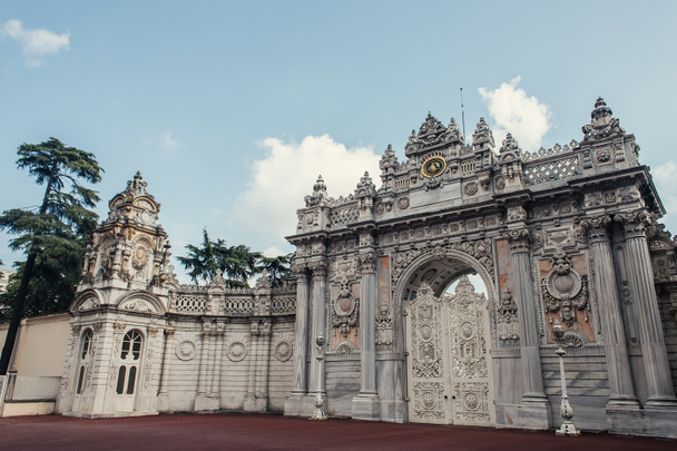 Gate of historical Dolmabahce palace and clouds in sky at background, Istanbul, Turkey  - Photo, Image