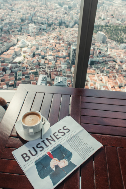 coffee cup and business newspaper on table in cafe with aerial view of Istanbul, Turkey - Photo, Image