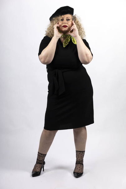 A vertical shot of a mature plus-size female model wearing black clothes on a white background - Foto, Imagen