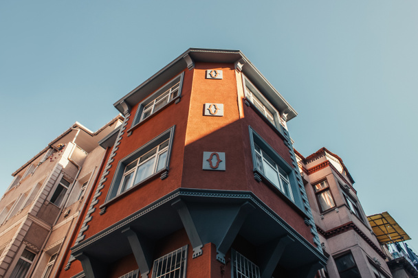 Низкоугольный вид на красный дом с резным декором в квартале Балат, Стамбул, Турция - Фото, изображение