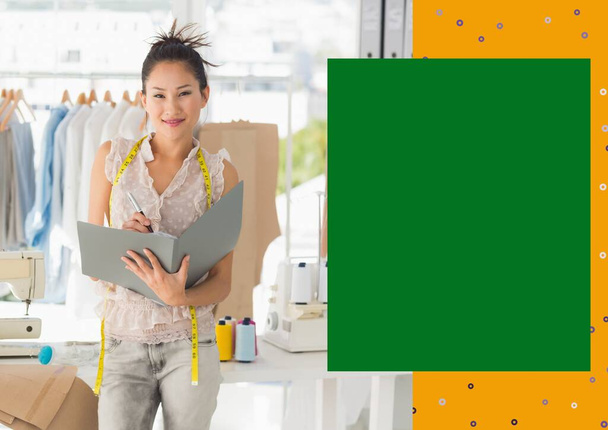 Portrait of smiling asian female fashion designer at work with yellow and green copy space on right. creative businesswoman concept, digitally generated image. - Φωτογραφία, εικόνα