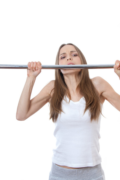 Woman exercising on pull-up bar - Фото, зображення