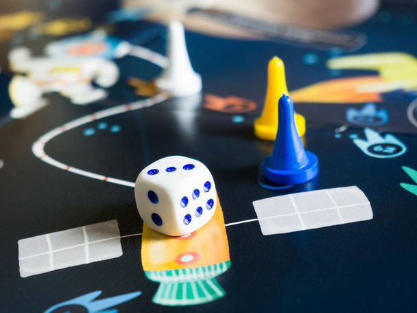 The concept of the board game is a board board, many pieces, dice, home entertainment for the family - Фото, изображение