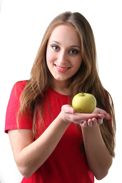 The isolated portrait of the young woman on white background eating apple - 写真・画像