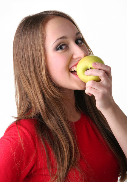 The isolated portrait of the young woman on white background eating apple - Φωτογραφία, εικόνα